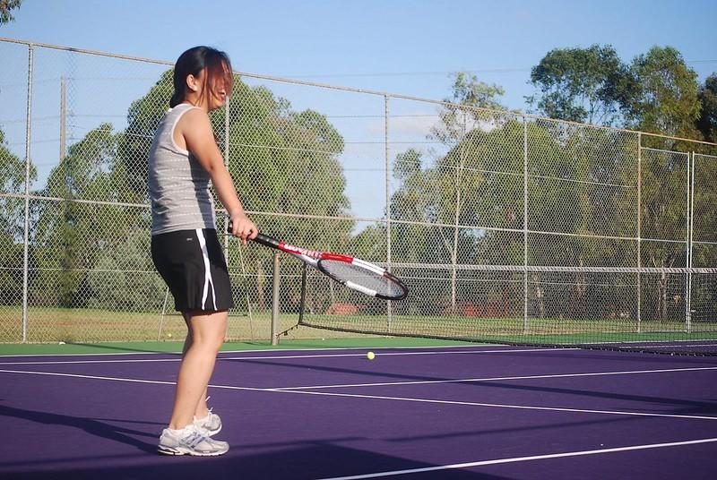 A tennis player enjoys herself despite a failed rally