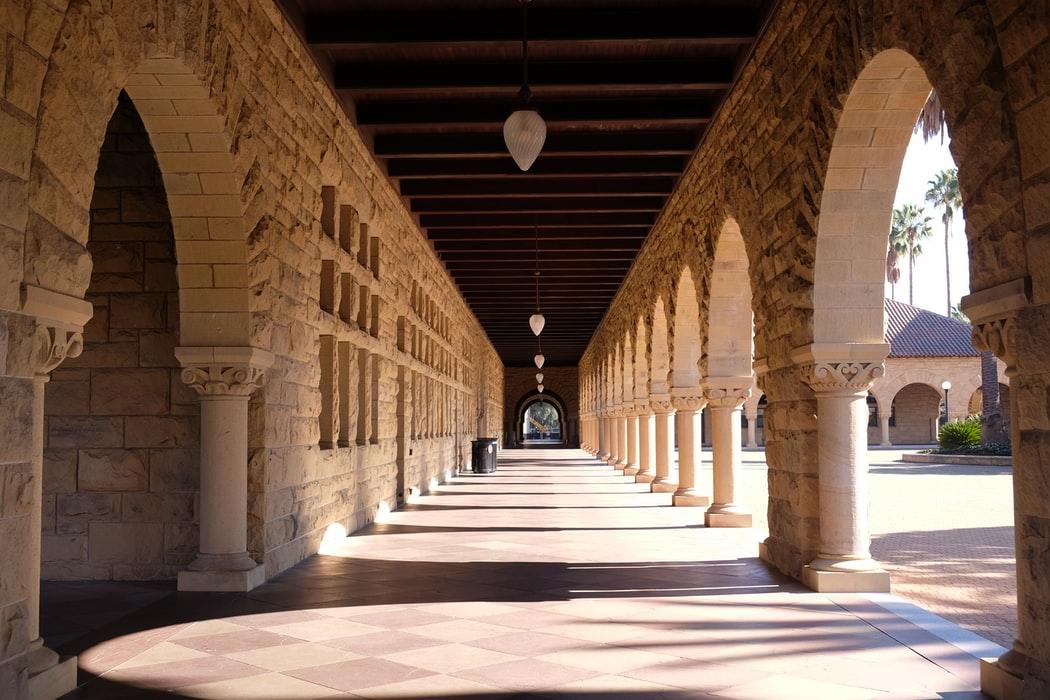 The brown and white concrete building of Stanford University