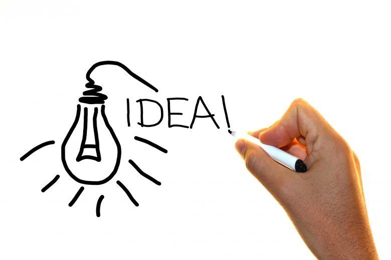 A lightbulb and the word idea drawn on a whiteboard