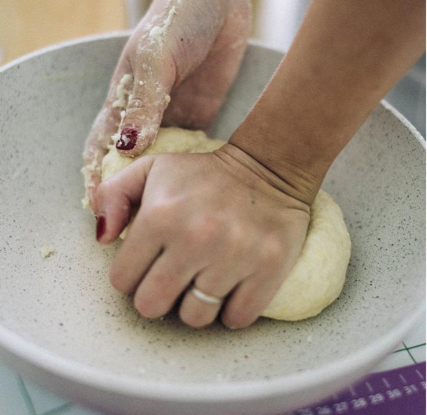 Girl kneading French pastry dough to make pie