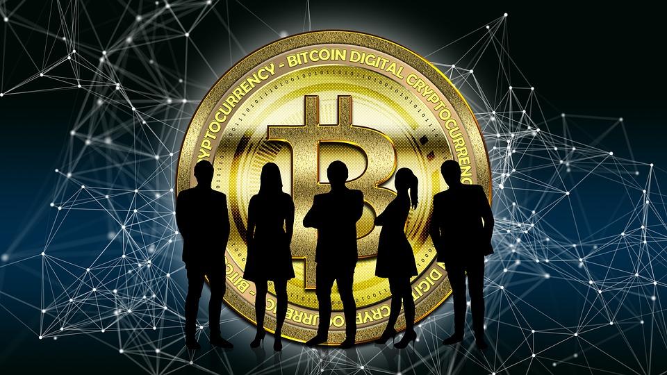 A group of people standing in front of the bitcoin logo