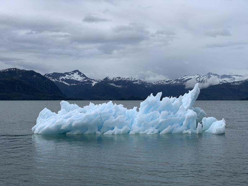An iceberg emerging from a body of water
