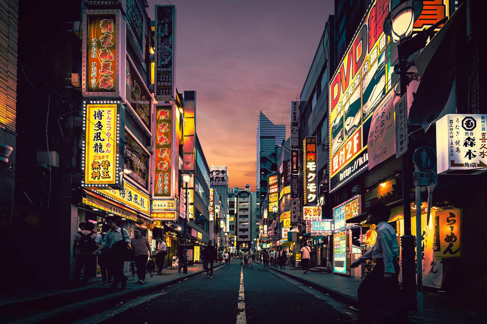 Japanese city street and light-up signs at dusk