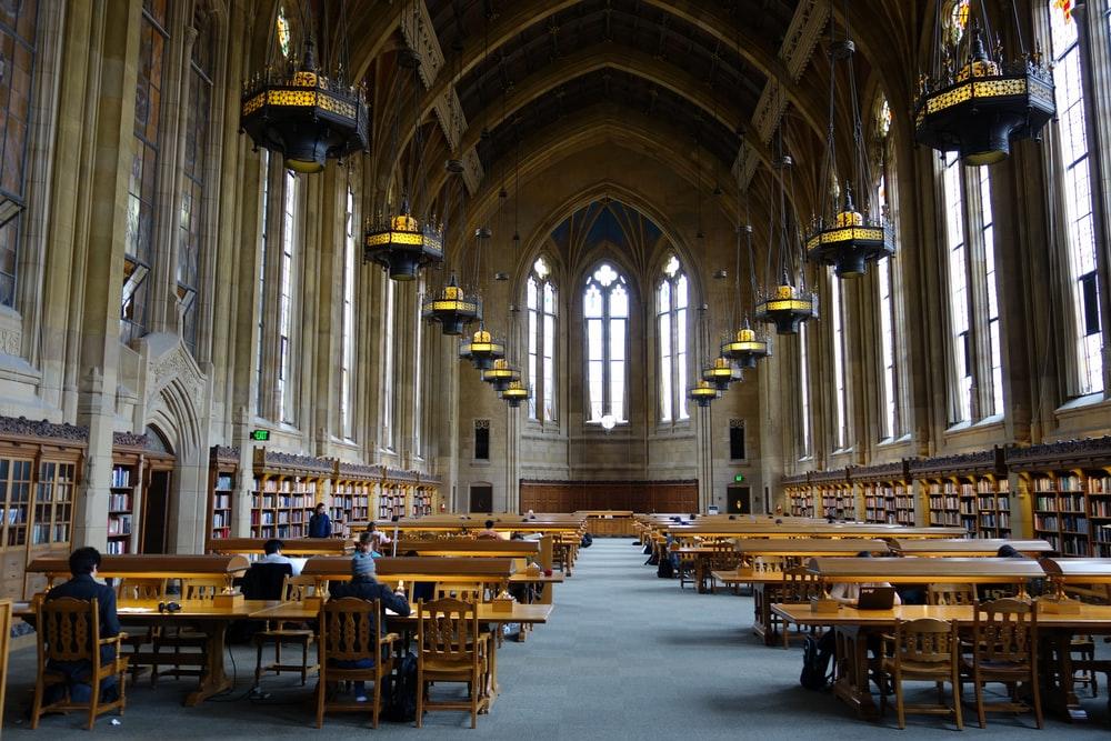 A considerable library hall of a university with few students studying