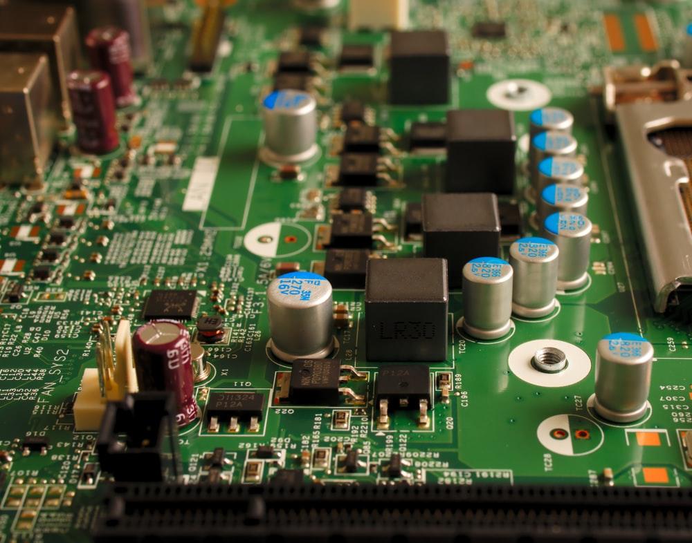 A close-up view of computer motherboard with lots of microcircuits, components, and ICs