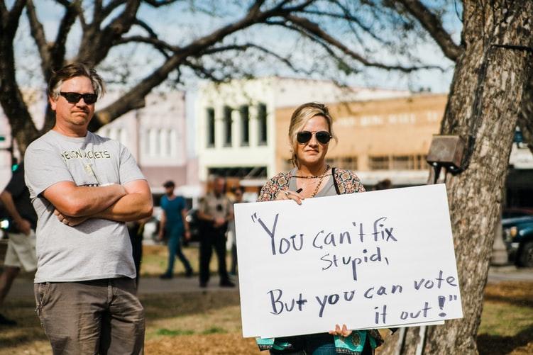 A couple holding a protest sign