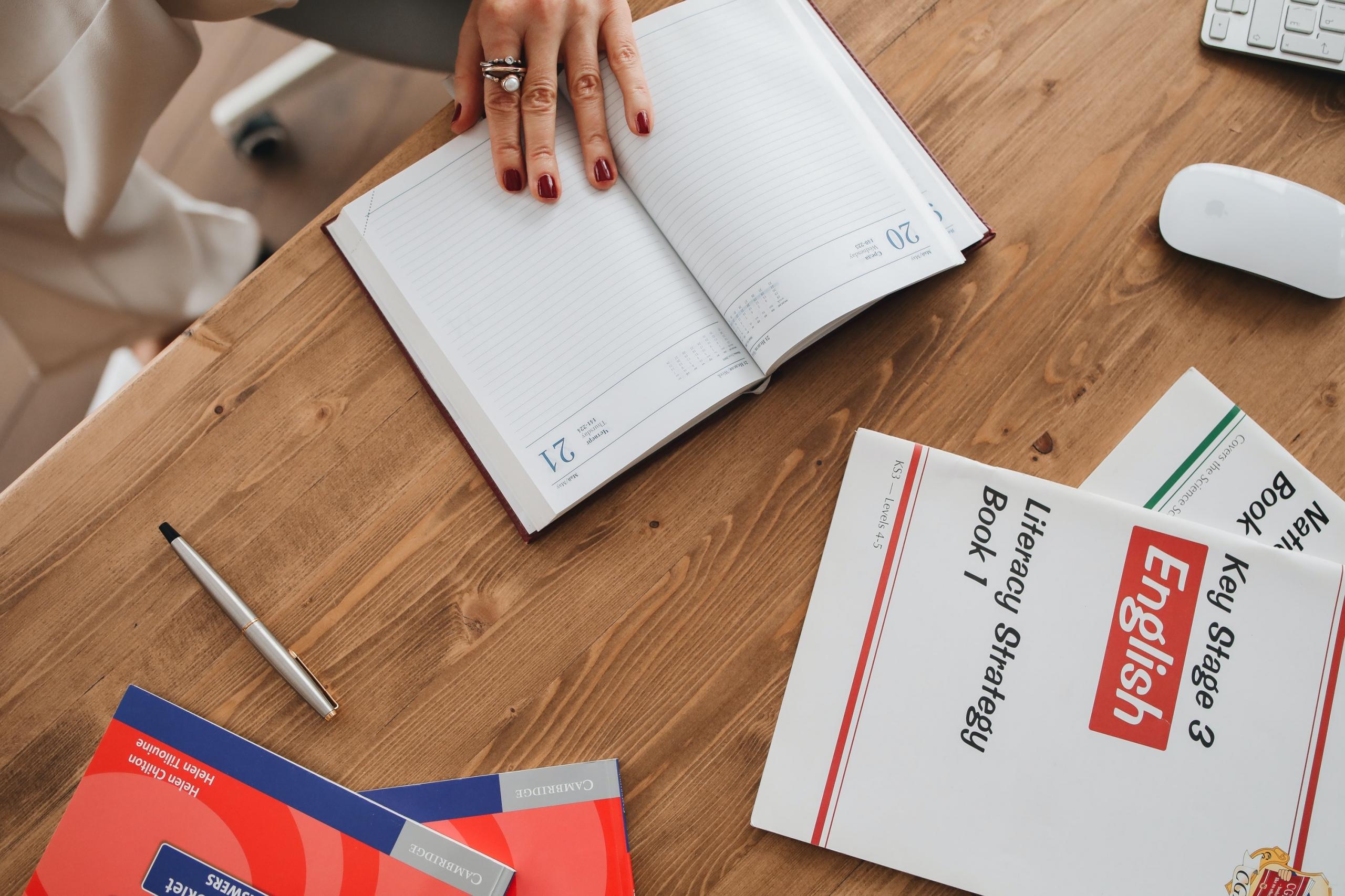 Books on a desk with a tutor