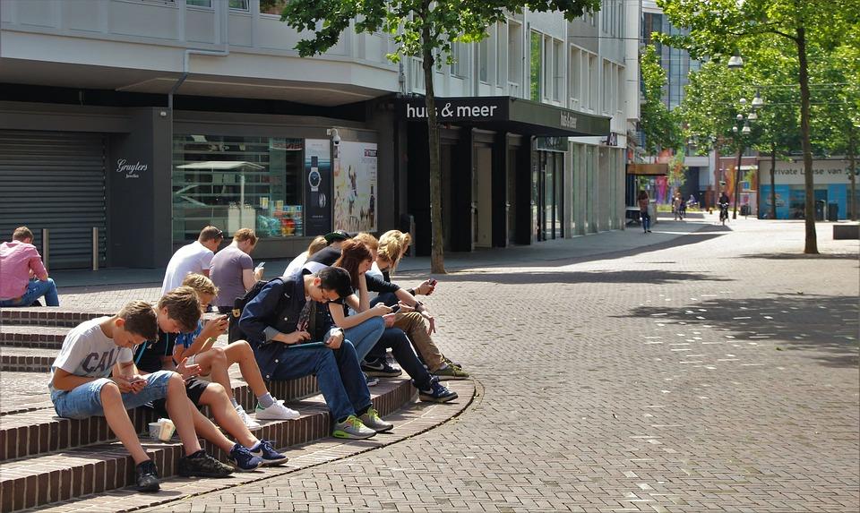 A group of young people sitting outdoors