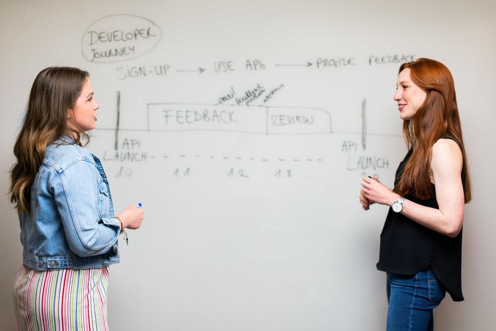 A teacher and student in front of a whiteboard