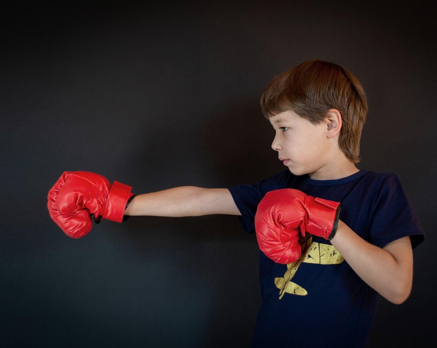 A young child learns how to throw a jab