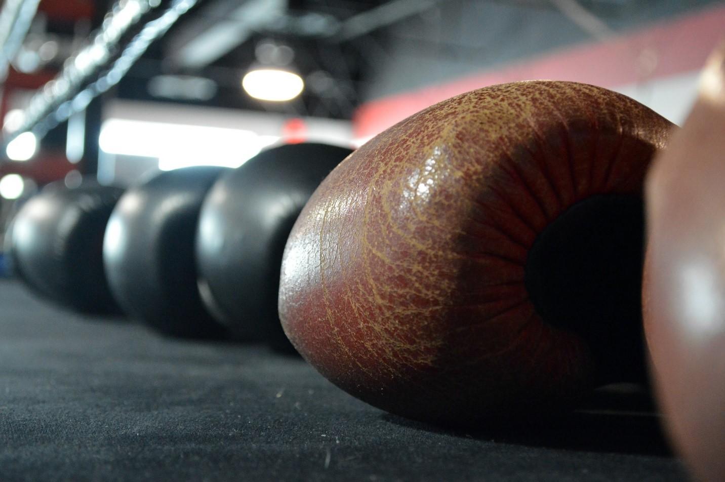 A selection of black boxing gloves in a ring