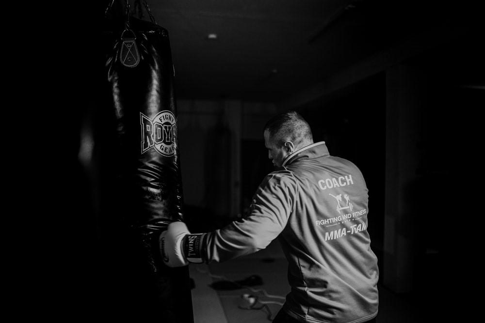 A man throwing punches at a punching bag