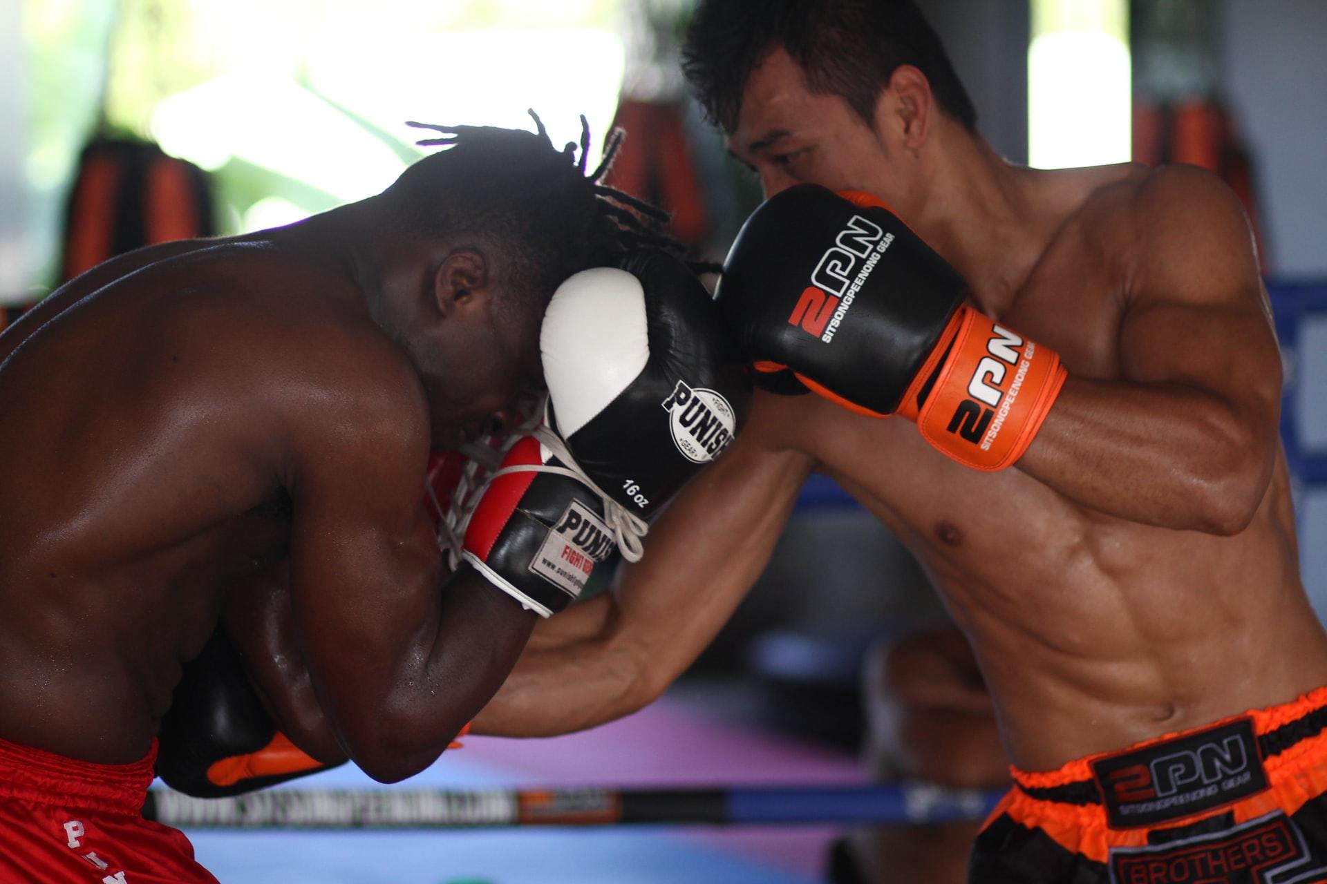 Two men sparring in a boxing ring