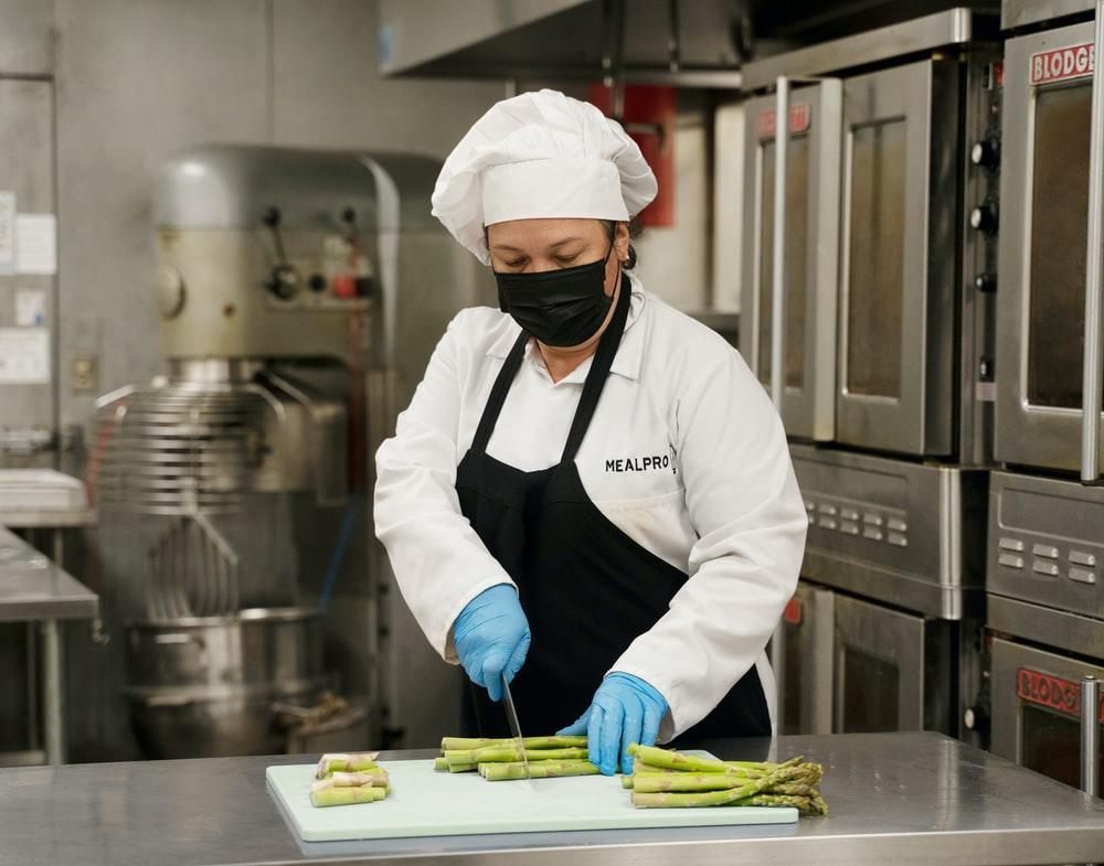 A chef cutting asparagus in the kitchen