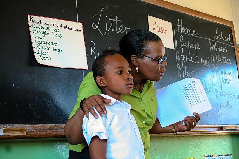 A teacher and student presenting on pollution