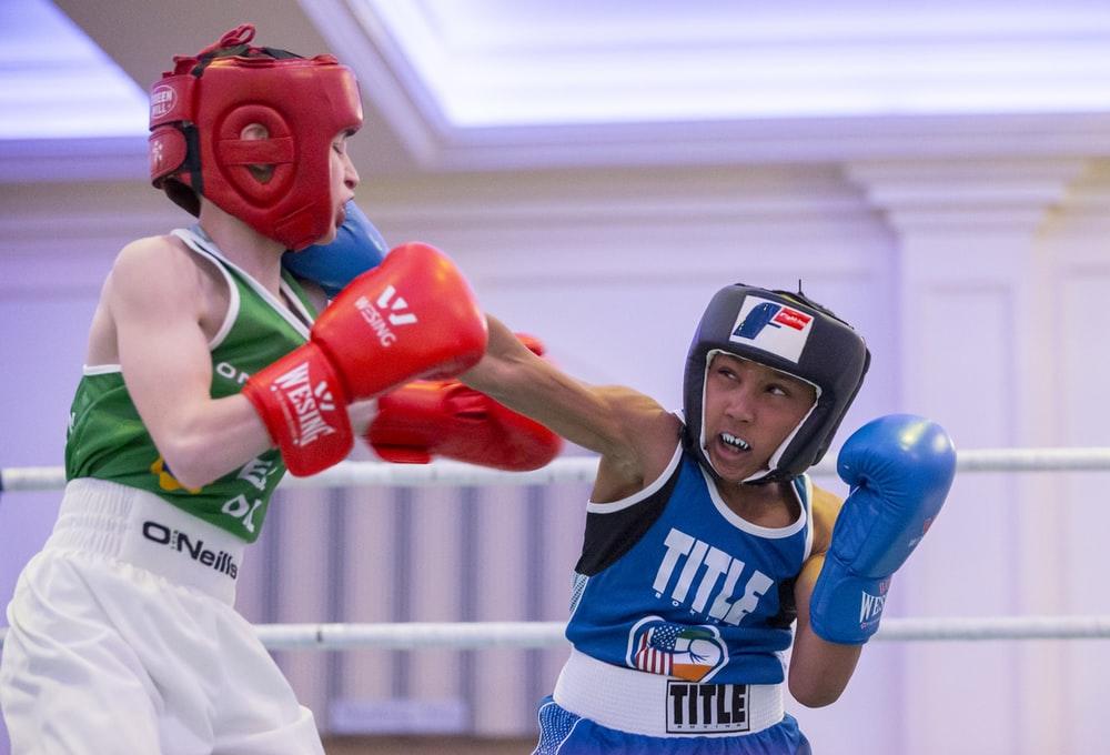 Two kids sparring while wearing proper boxing gear