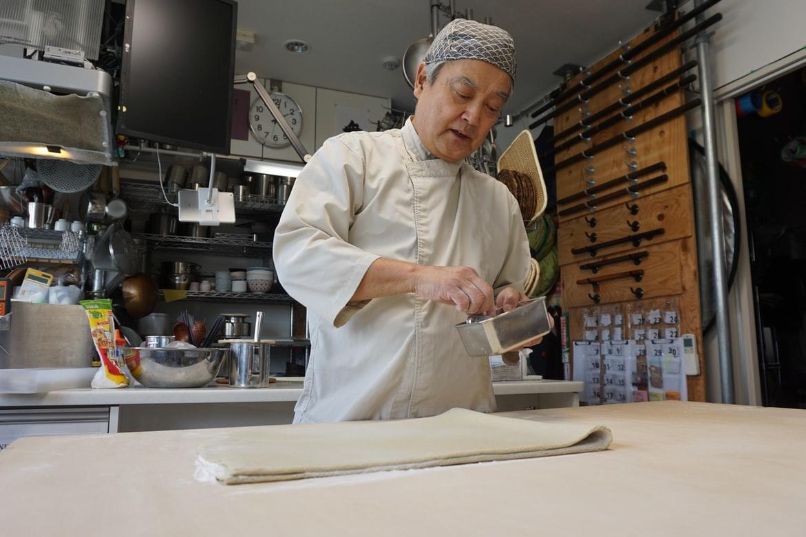 A pastry chef making dessert in his kitchen