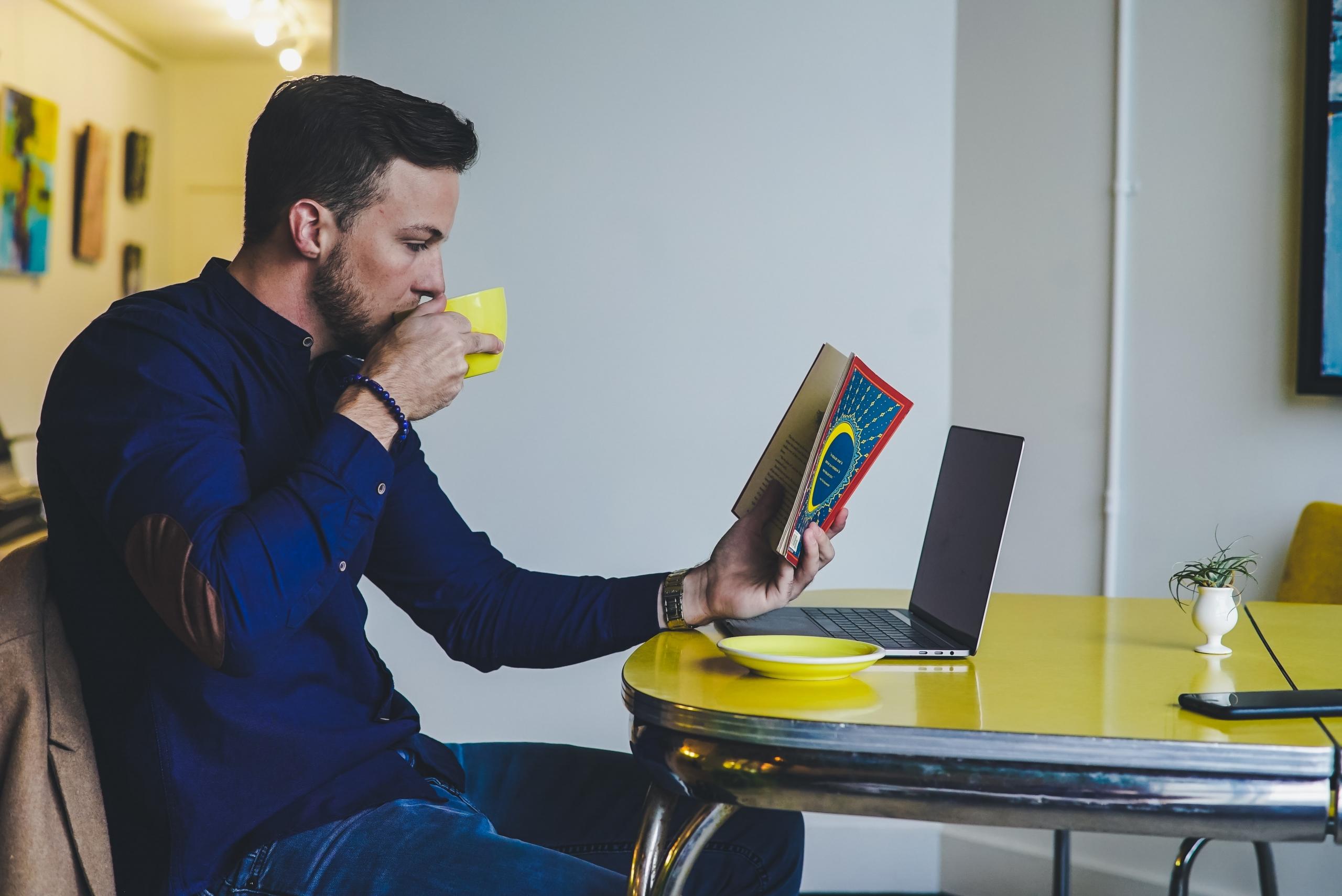 Man reading while having coffee