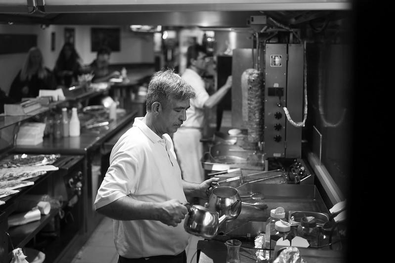 A chef is using eco-friendly kitchen appliances to make tea