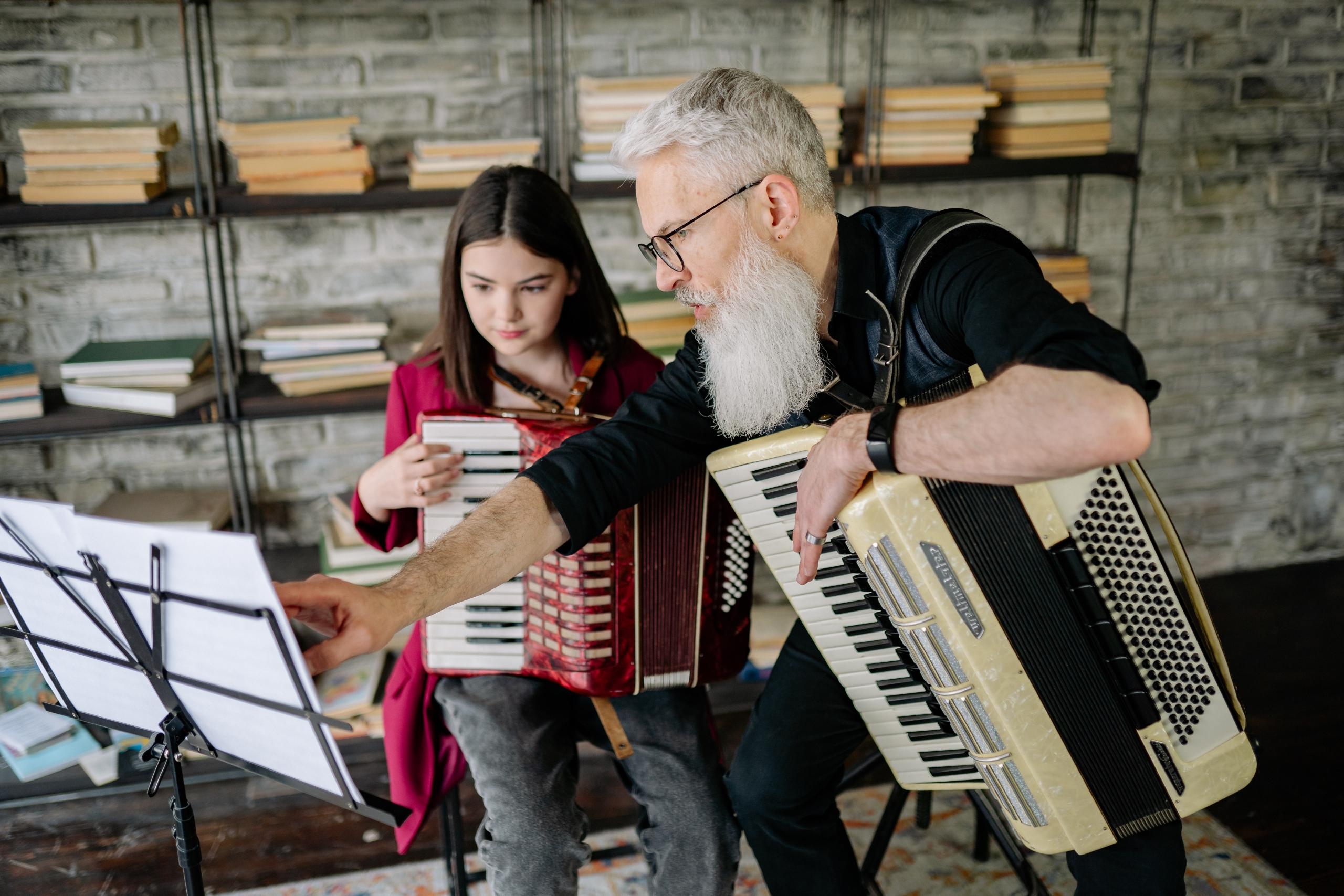 Music teacher working with student