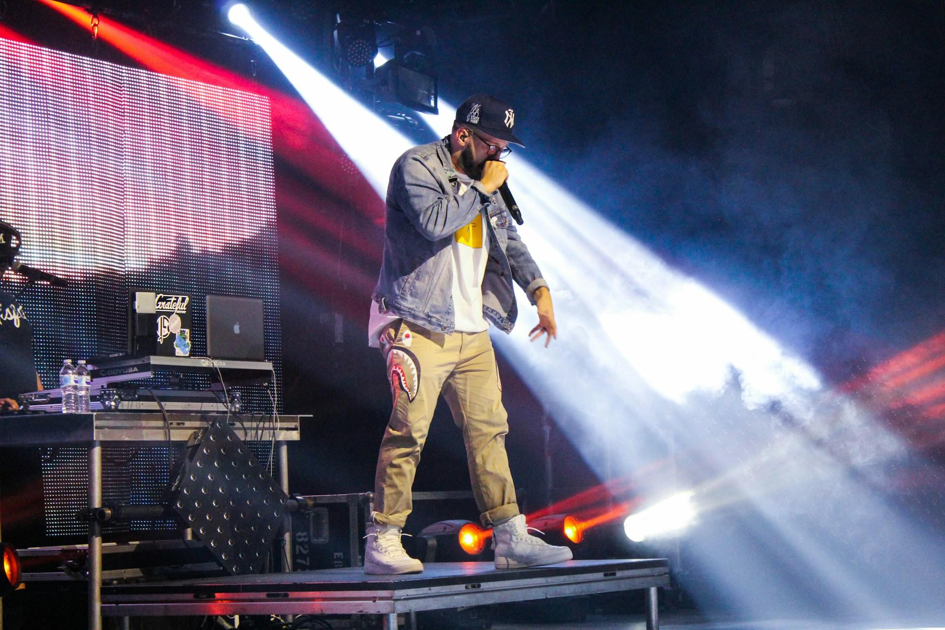 A rapper on stage performing.