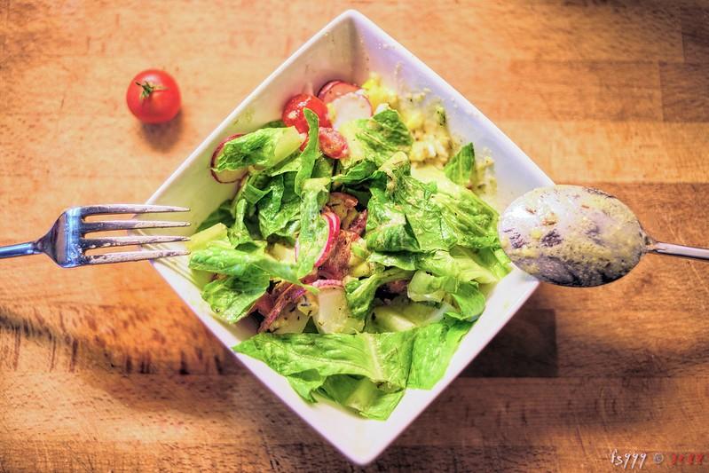 A bowl of salad made from leftover food