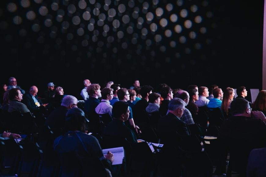 Business students noting down lectures during a class