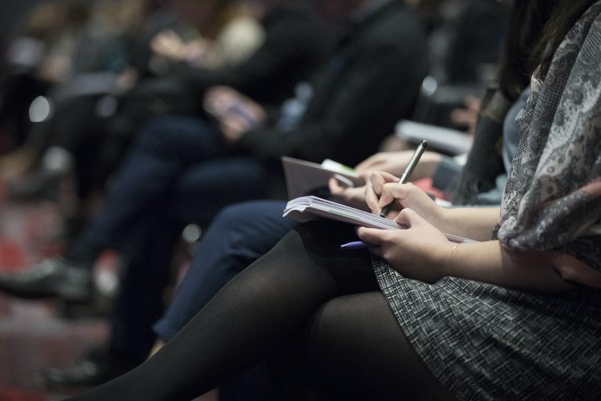 A student jotting down an introductory lecture during her session
