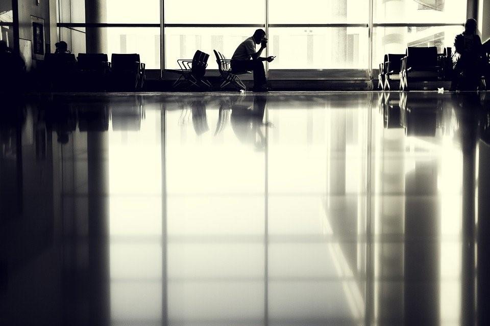 Student waiting at the airport for his flight abroad