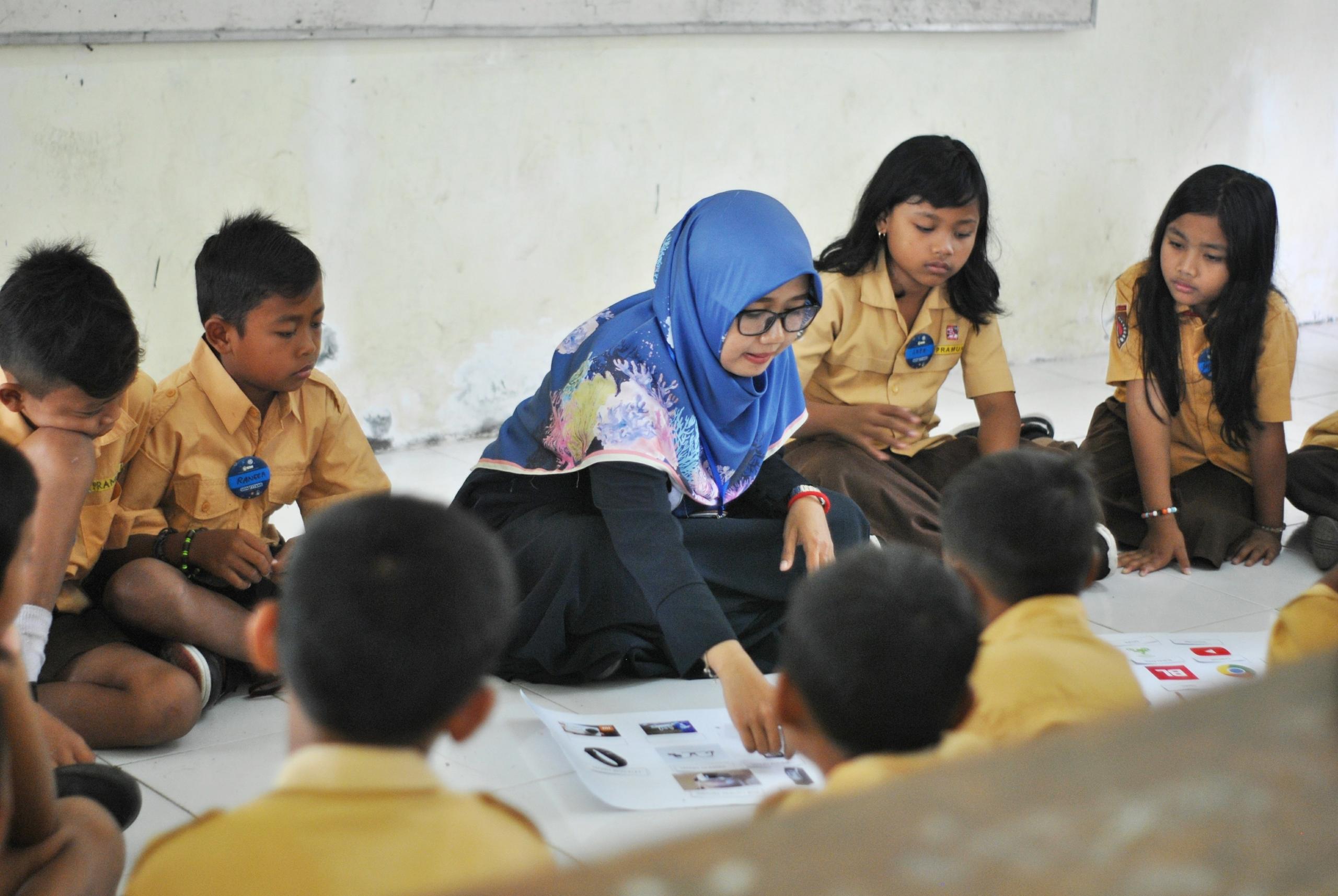 Female Arabic teacher busy teaching Arabic to her pupils in the class