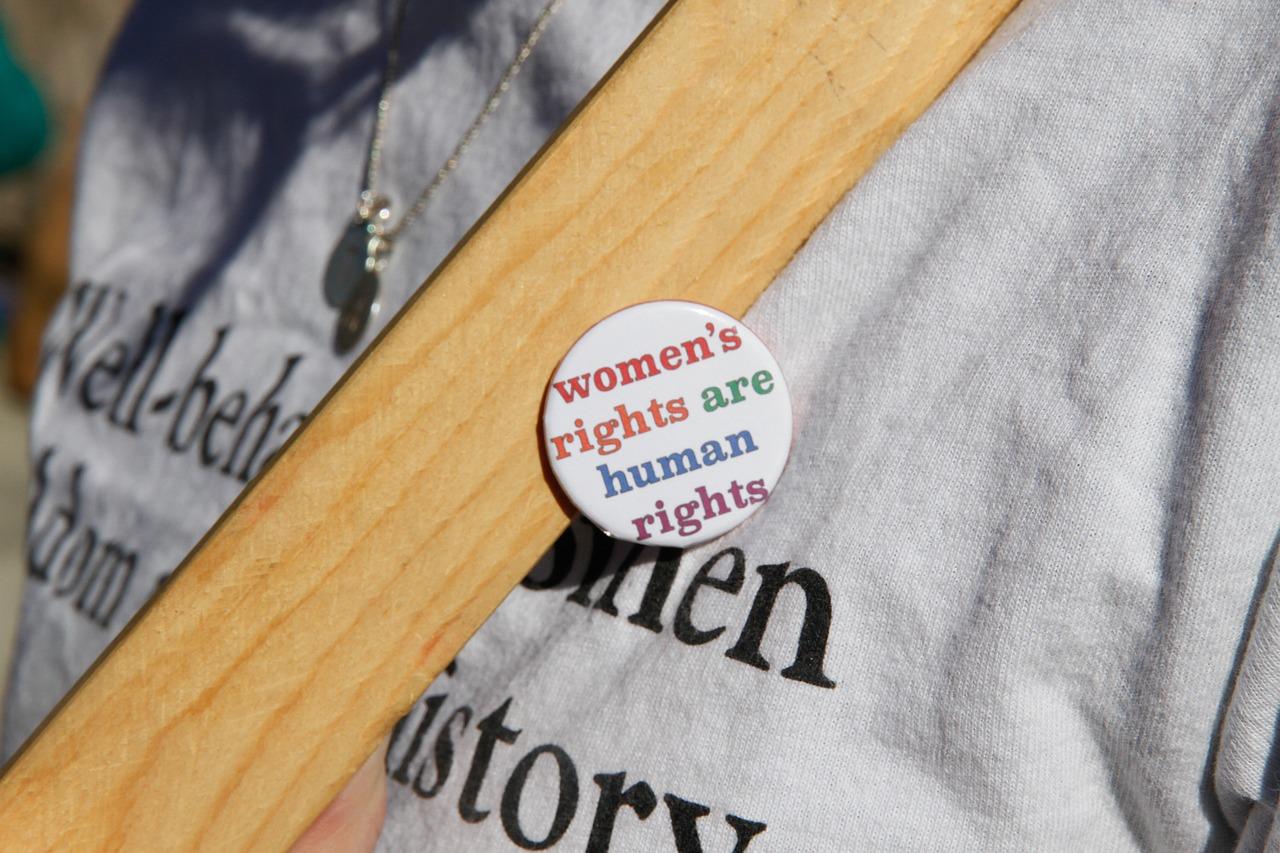 girl with feminist pin