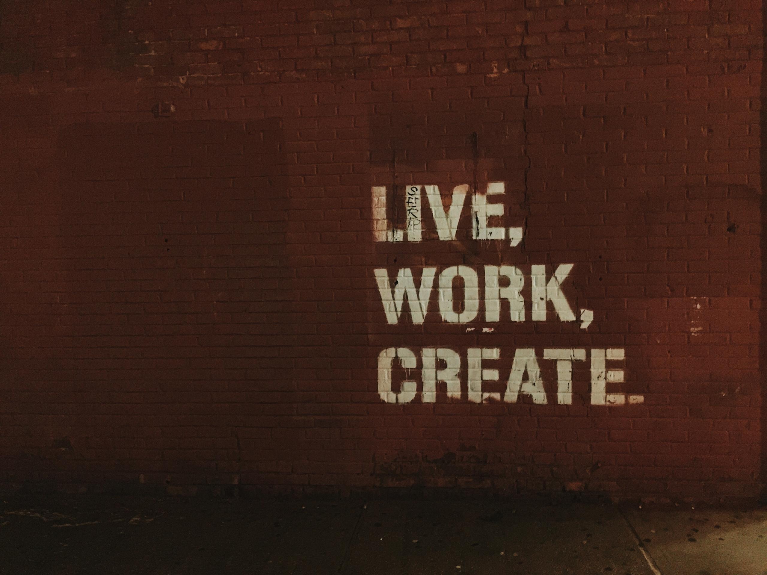Stencil graffiti on a red-brick wall