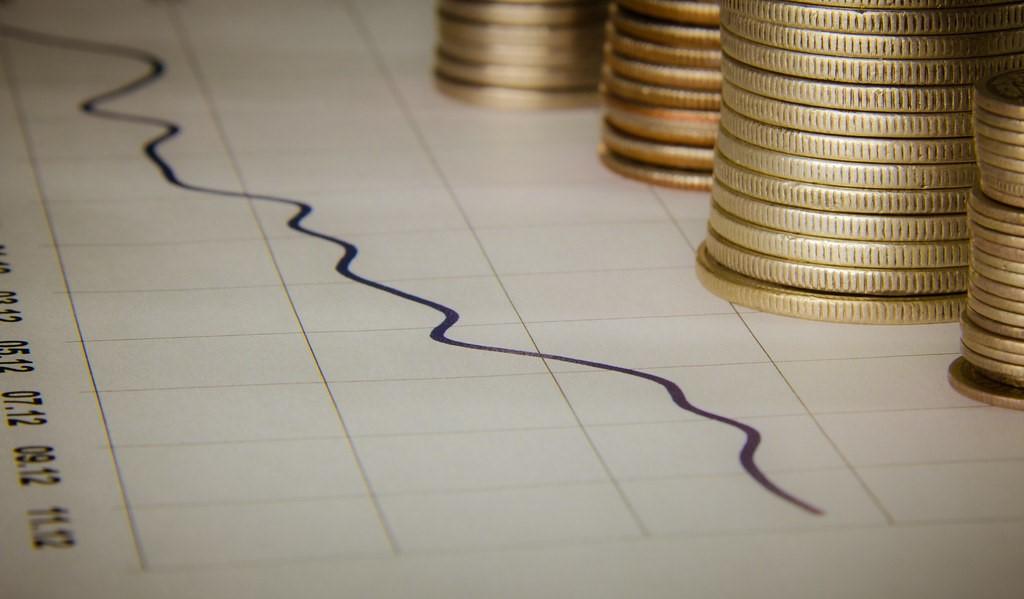 An improving graph depicted next to a stack of coins