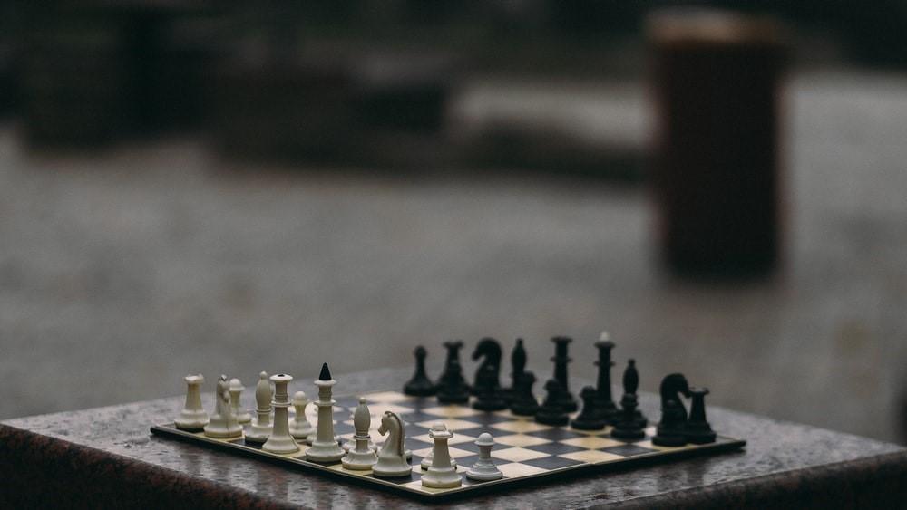 A standard chessboard on a marble table