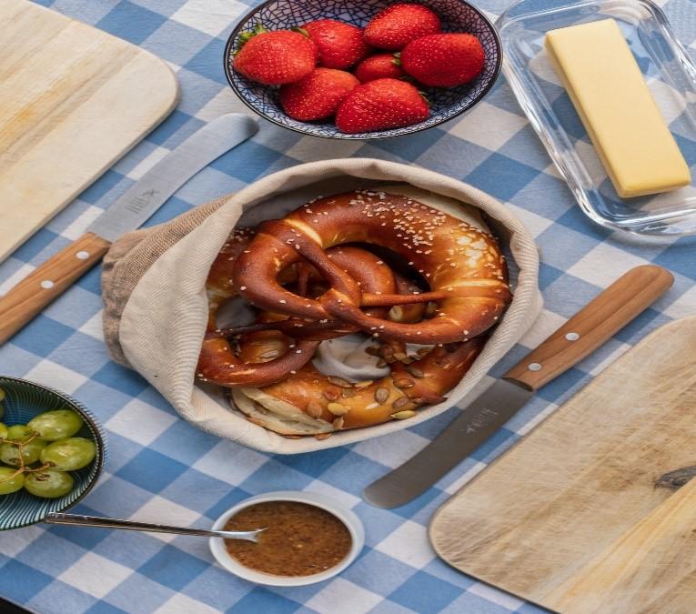Pretzels, grapes, and strawberries on a table for Oktoberfest