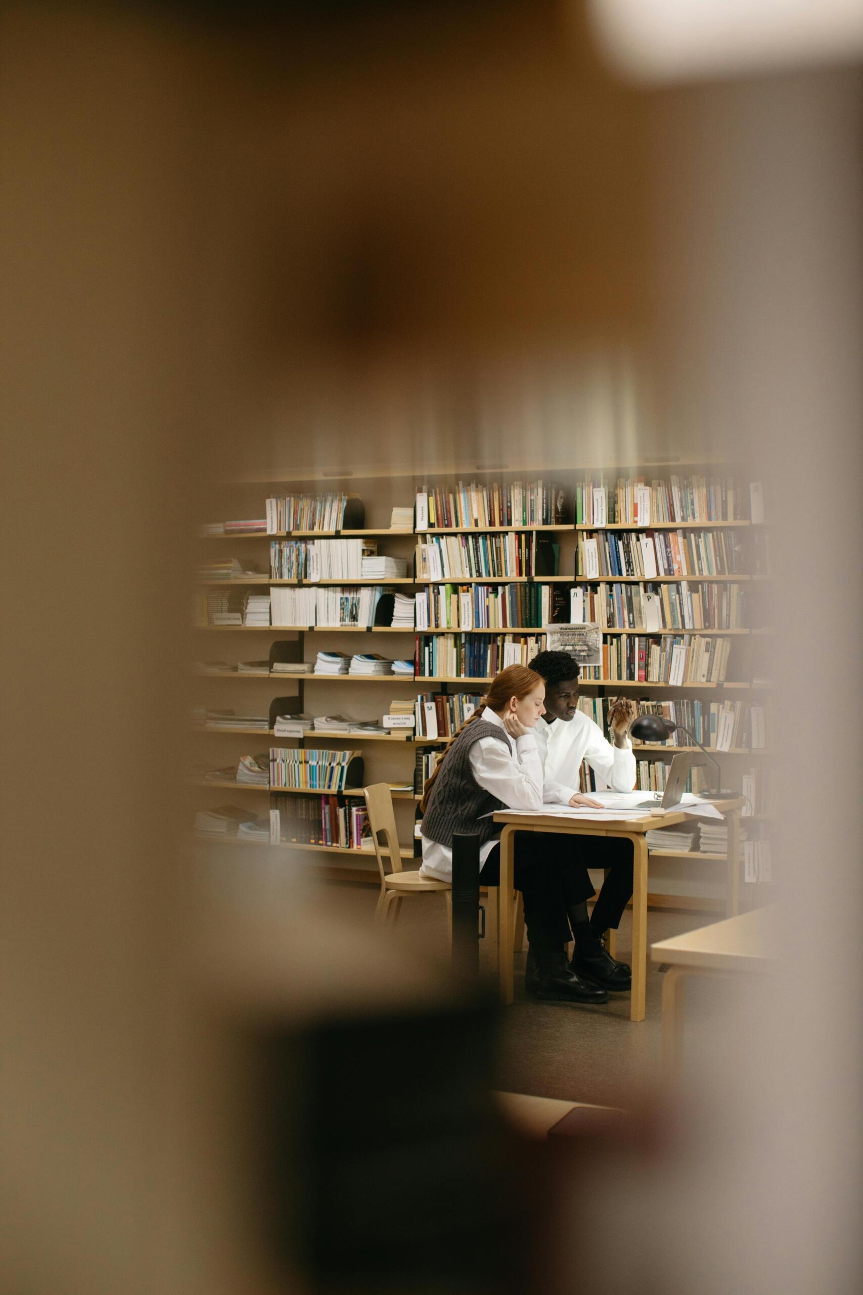 A group of students gathered together at a library, discussing student body issues.