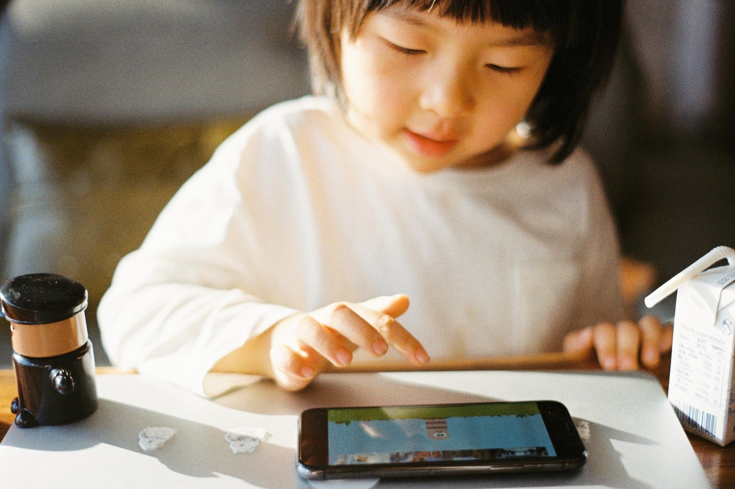 child playing with tablet