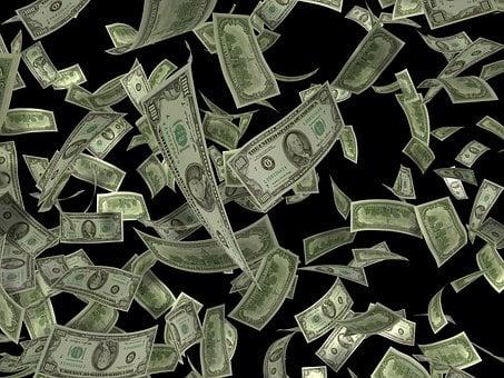 Several hundred dollar notes falling down