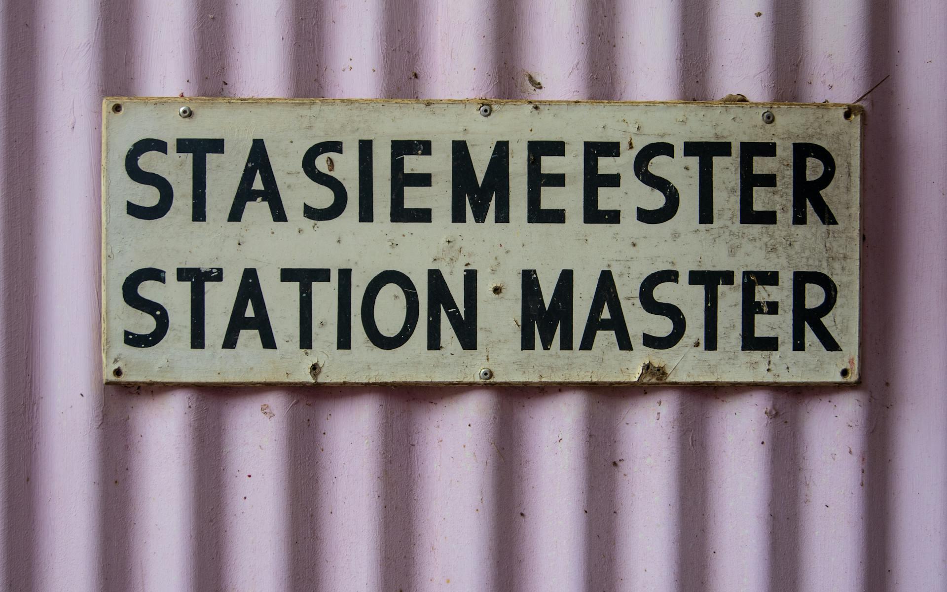 The words station master in English and Afrikaans