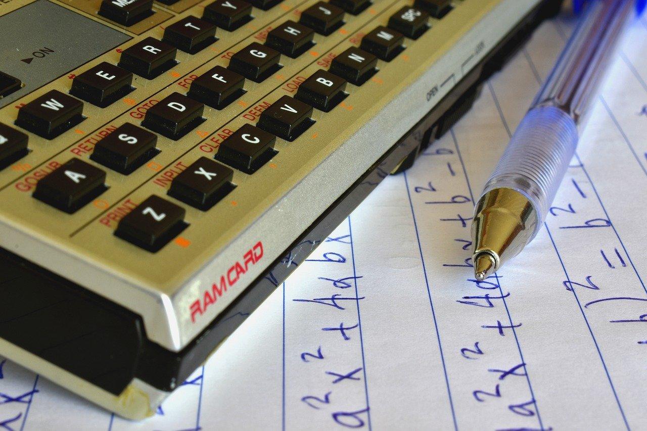 calculator with pen and equations