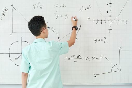 A bright young high-schooler is solving geometric problems on the whiteboard