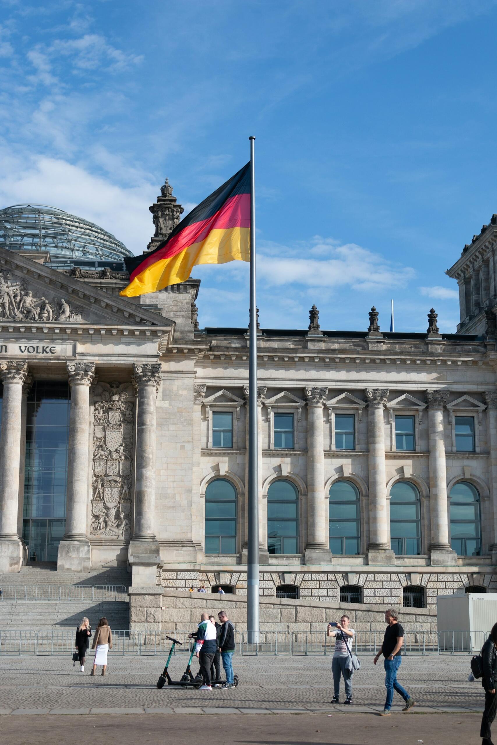 A german flag flies outside the reichstag