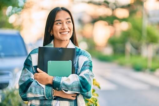 A young girl who is happy after securing good grades in her first Latin test