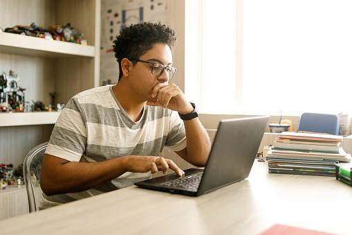 A high-schooler concentrating on his Latin lessons