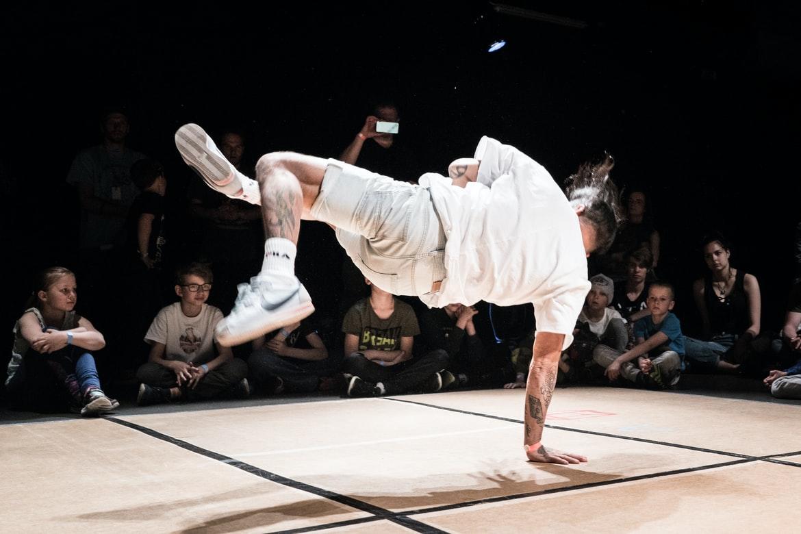 A breakdancer performing b-boy moves on the dance floor