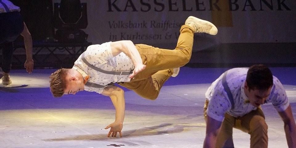 A man doing a handstand while breakdancing