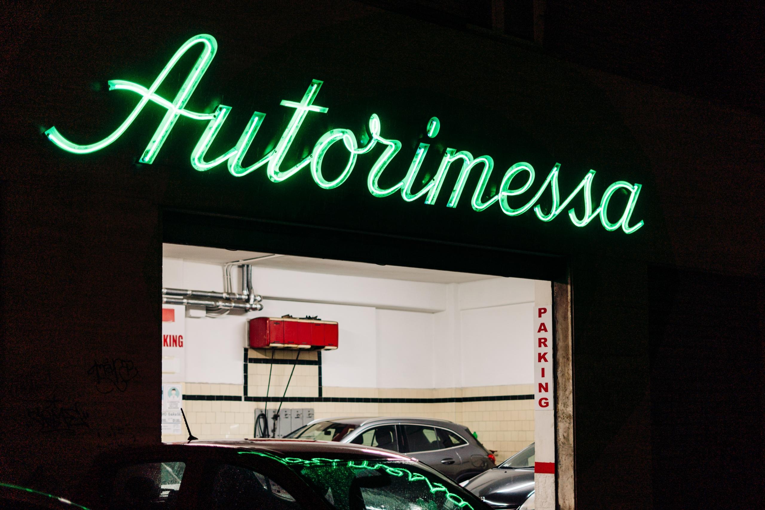 A Neon Signboard reading 'Autorimessa' meaning garage