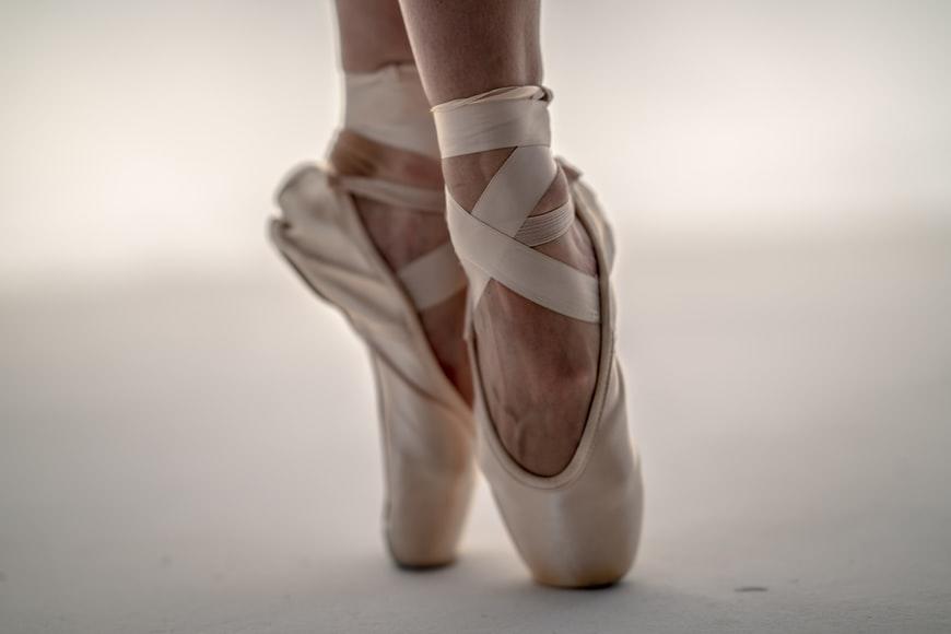A Ballet dancer balancing her body on her toes