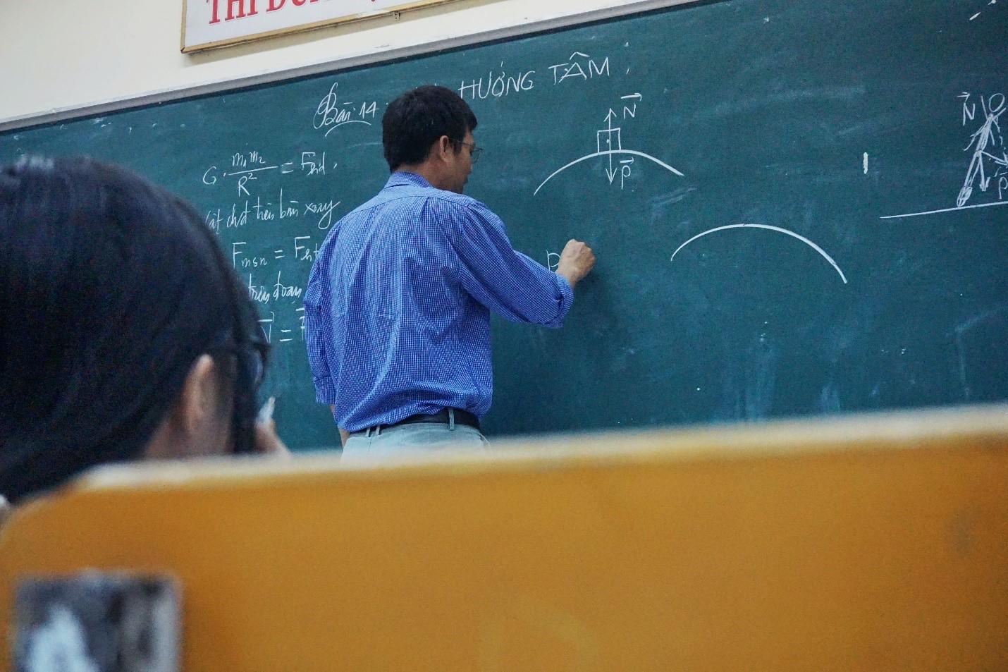 Mathematic formulas and equations written on a board with chalk