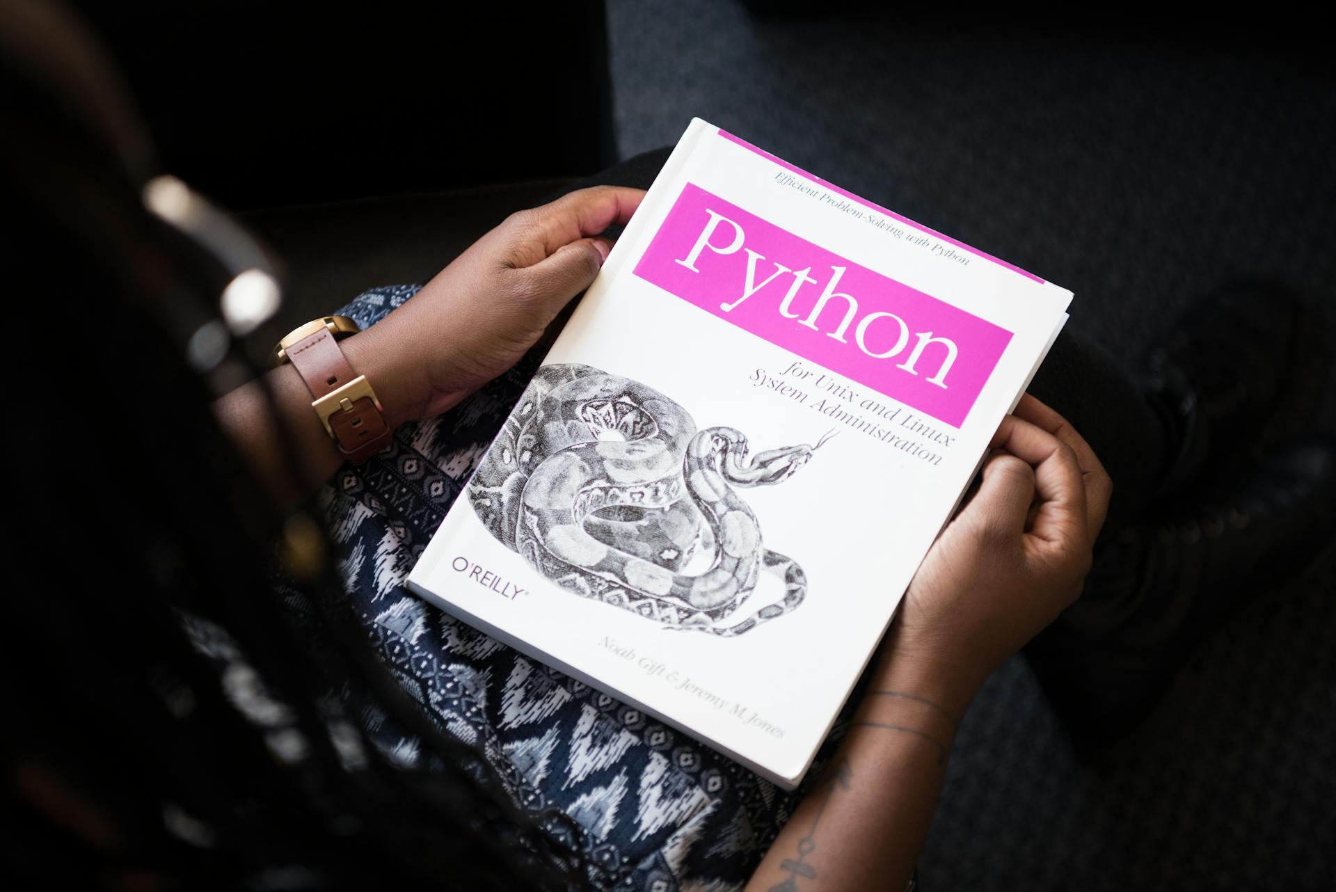 Someone holding a Python book.